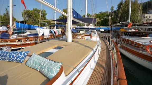 Among Marmaris yacht rental options Eloa front deck shows sunbeds and side walkway in marina setting.