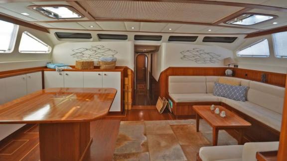 Among Marmaris yacht rental options Eloa interior shows spacious seating area and table for comfortable onboard living.
