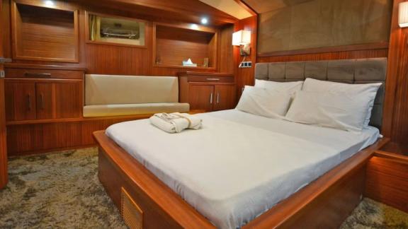 Among Marmaris yacht rental options Eloa cabin shows double bed and small seating area for comfort.