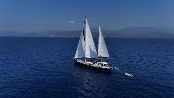 Among Marmaris yacht rental options Eloa is sailing in open sea with sails up and wide horizon view.