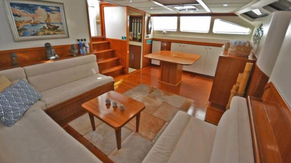 Among Marmaris yacht rental options Eloa interior shows lounge with seating area and dining table for guests.