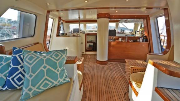 Among Marmaris yacht rental options Eloa seating area shows large table and comfortable cushions for relaxation.