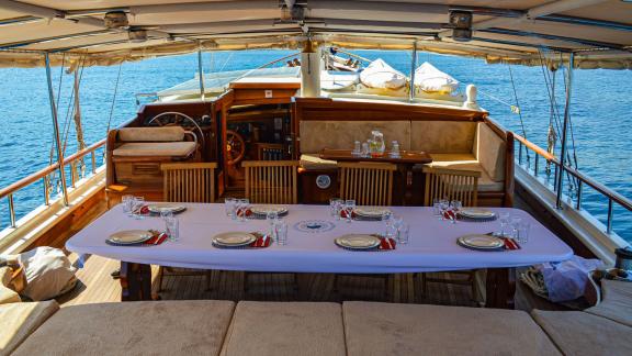 A stylishly laid dining table on the enderim A with a sea view.