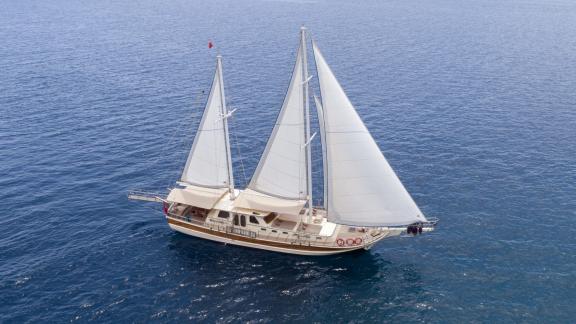 Luxurious 4-cabin Gulet Faralya sailing on calm sea, available for charter in Marmaris.