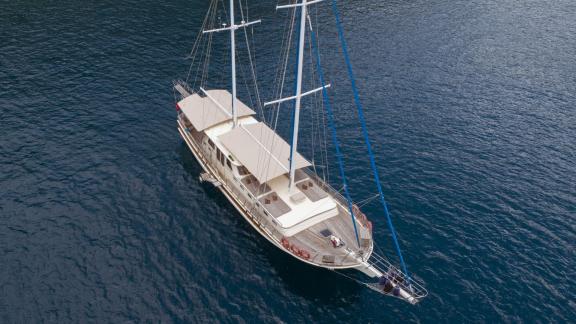 Stunning aerial view of a luxurious 4-cabin gulet on calm waters.