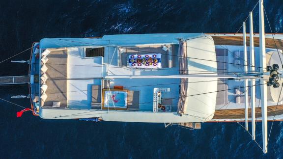 Top view of the Gulet Freedom in Marmaris, showing the deck with dining table and sunbeds.