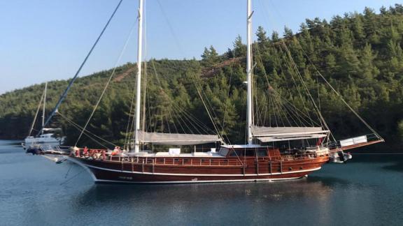 The magnificent Gulet Galip Nur against a scenic forest backdrop in Marmaris