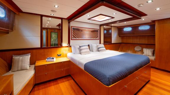 In Göcek gulet charter option Getaway master cabin with large bed seating area and spacious interior visible.