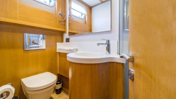 In Fethiye gulet charter option Happy Days bathroom with sink toilet and shower area visible.