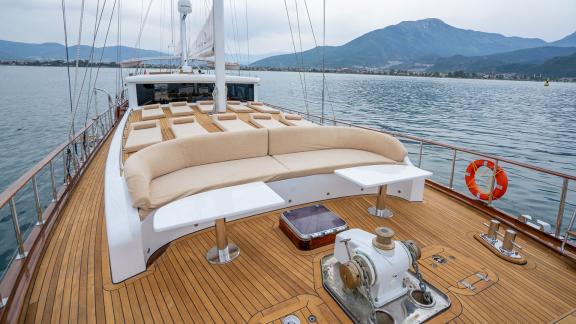 In Fethiye gulet charter option Happy Days foredeck with seating area and sun cushions visible.