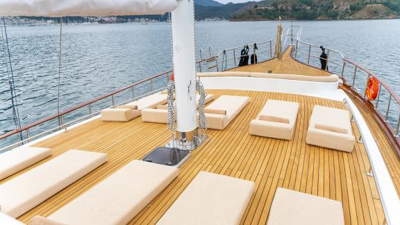 In Fethiye gulet charter option Happy Days foredeck with sunbeds and relaxation area visible.
