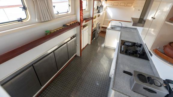 Well-equipped kitchen with stove, sink, and storage on Yacht Kanarya.