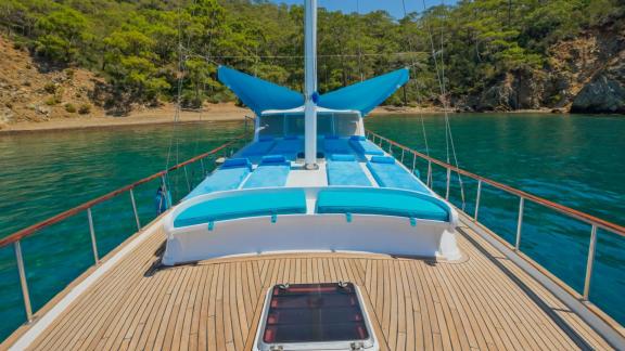 Relax on the spacious sun deck of the Gulet Mandala in the tranquil waters of Göcek.