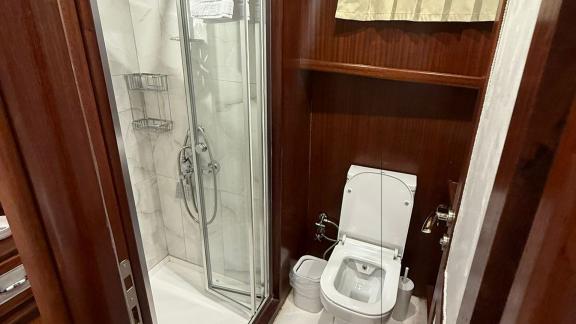 In der Mare Magico Mietgulet in Marmaris sind Duschkabine, WC und Holzverkleidung zu sehen.