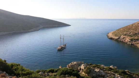 The gulet Matina is peacefully anchored in a secluded bay in Greece surrounded by rocky hills