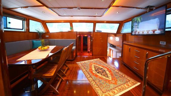 Stylishly furnished saloon inside the Gulet Maya with cosy dining area.