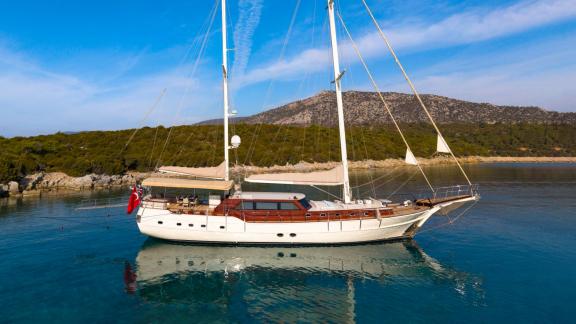 Mein Schatz is anchored in a picturesque bay with crystal-clear waters, perfect for gulet charter in Bodrum.