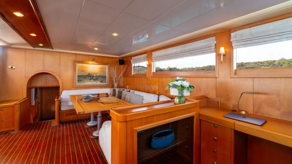 The saloon of Mein Schatz, with warm wood decor and a spacious seating area, is perfect for a gulet charter in Bodrum.