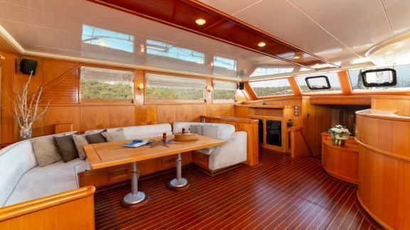 The saloon of Mein Schatz, with large windows and stylish seating, is perfect for a weekly gulet charter in Bodrum.