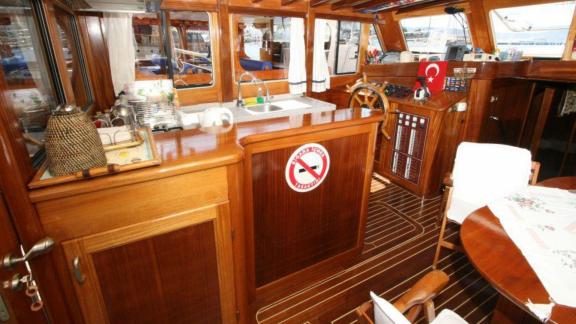 Functional galley and helm station on Gulet Miramare with elegant wood paneling, perfect for onboard operations.