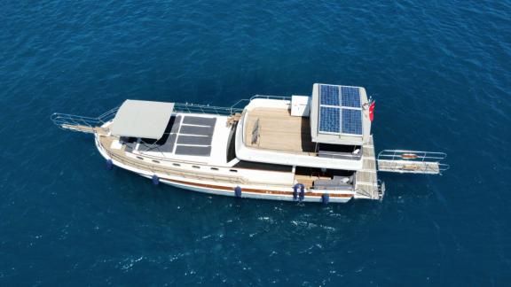 This gulet is equipped with solar panels, sailing on the clear, open sea, perfect for eco-friendly trips.