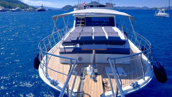 The spacious sun deck of this gulet offers comfortable loungers with views of the blue sea and surrounding islands.