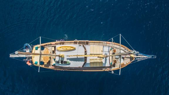 Stunning bird's eye view of Gulet Nikola on clear blue waters. Unique yachting experience.