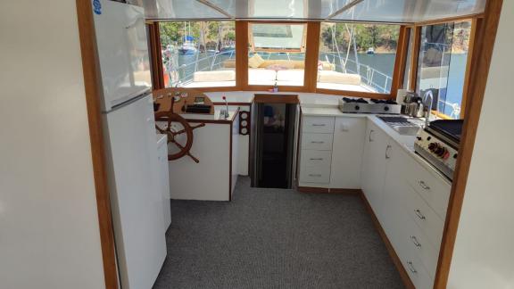 Modern helm and well-equipped kitchen on Gulet Nostalji with a view of the water.