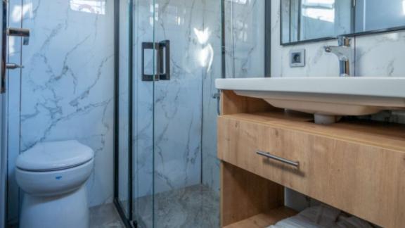 Princess Alize gulet features a modern bathroom with a glass shower cabin and stylish sink area onboard.