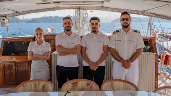 The experienced crew of Princess Alize gulet welcomes guests onboard during a luxury blue cruise holiday.