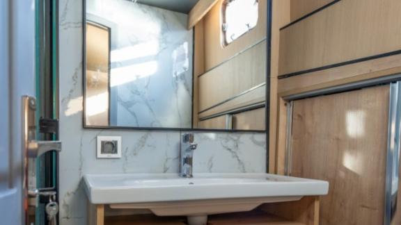 Princess Alize gulet features a stylish bathroom with a spacious sink area and modern wooden details onboard.
