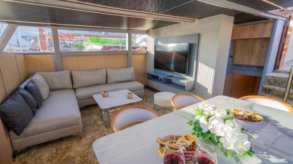 Princess Alize gulet features a stylish indoor lounge with comfortable seating and a television area onboard.