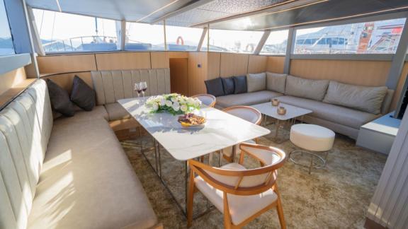 Princess Alize gulet features a spacious indoor lounge with comfortable seating and a modern dining area onboard.