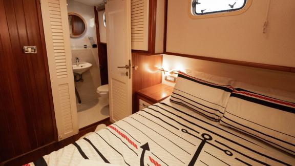 Among Fethiye yacht rental options Queen Alin cabin shows double bed with direct access to bathroom onboard.