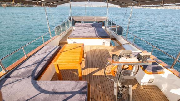 Among Fethiye yacht rental options Queen Alin upper deck shows seating areas and sunbeds for relaxation.