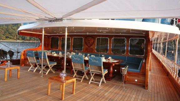 The spacious aft deck of the gulet Queen Atlantis offers a perfect dining area for luxury gulet charter in Fethiye.