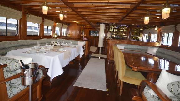 The elegant interior of Queen Atlantis features comfortable seating and stylish dining tables.