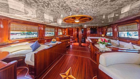 The luxurious interior of a sailing yacht with elegant wooden furniture and comfortable seating areas.