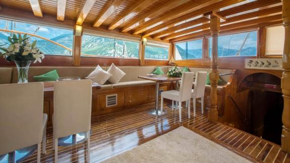 Elegant interior of a Gulet yacht with panoramic windows and comfortable seating. Enjoy the luxury.