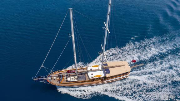 An elegant gulet from Bodrum with 6 cabins that sails over the blue water and leaves a trail of waves in its wake.