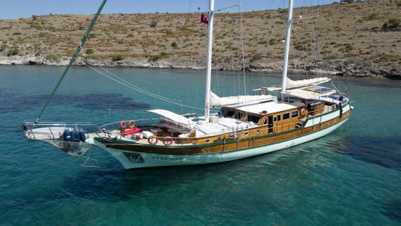 The beautiful wooden yacht Serenad off the coast of Bodrum, Turkey, in clear turquoise waters.