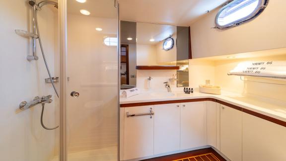 In Göcek gulet charter option Serenity 86 bathroom with shower cabin large sink and modern lighting offering comfort vis