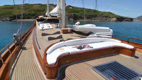 Spacious deck of the luxurious gulet Smyrna with sunbathing areas available for hire off the picturesque coast of Bodrum