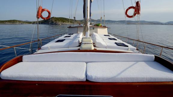 Relaxing sun deck on the Gulet Sıla with comfortable loungers and a beautiful view of the calm waters.