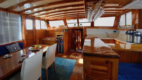 Stylish interior of the Gulet Sıla with a dining area, seating area, and well-equipped kitchen.