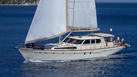In Bodrum gulet charter option Tango Charlie sailing at sea with sails open visible.