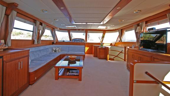 In Bodrum gulet charter option Tango Charlie interior salon with seating area and living space visible.