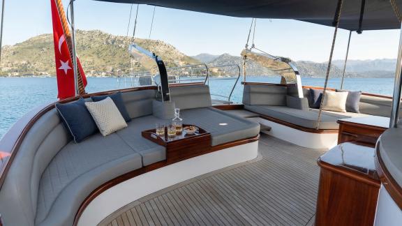 In Marmaris gulet charter option Tosca aft deck with seating and sea view offering relaxing and comfortable onboard expe
