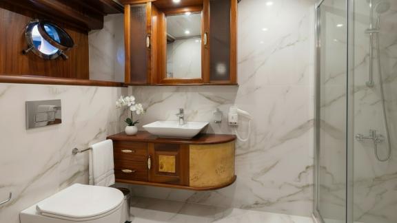 In Marmaris gulet charter option Tosca bathroom with shower and modern design offering practical and comfortable use.