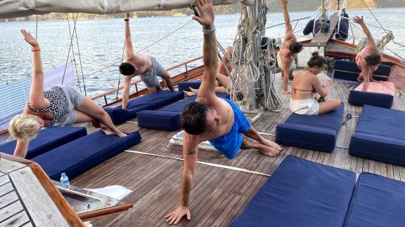 Yoga session on the deck of our Gulet, perfect for relaxation and wellness in Bodrum.